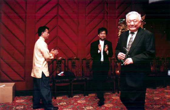 Image of Martin Yan, David Henry Wang, and honoree Ming Cho Lee