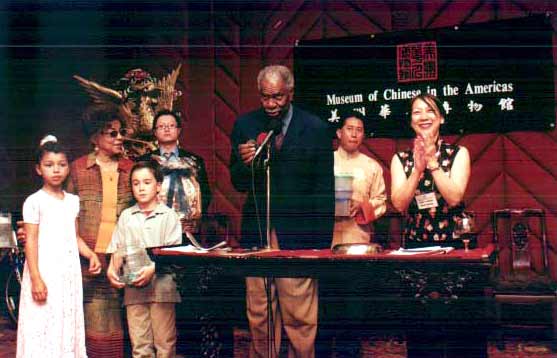 Actor Ossie Davis takes bids during the benefit auction